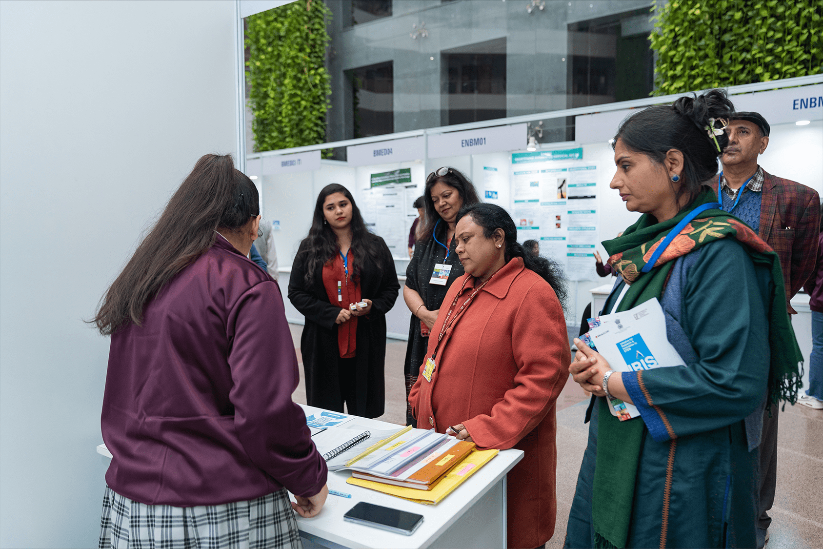Indian student presenting her research project at a poster booth
