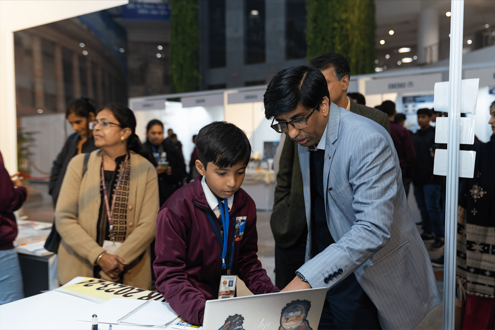 Young Indian student demonstrating his engineering project to a judge
